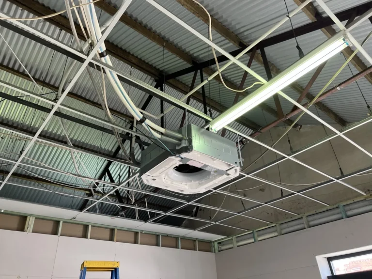 Exposed ceiling with air conditioning unit installation.