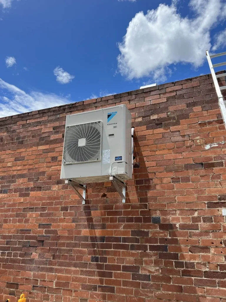 Wall-mounted air conditioner on brick wall