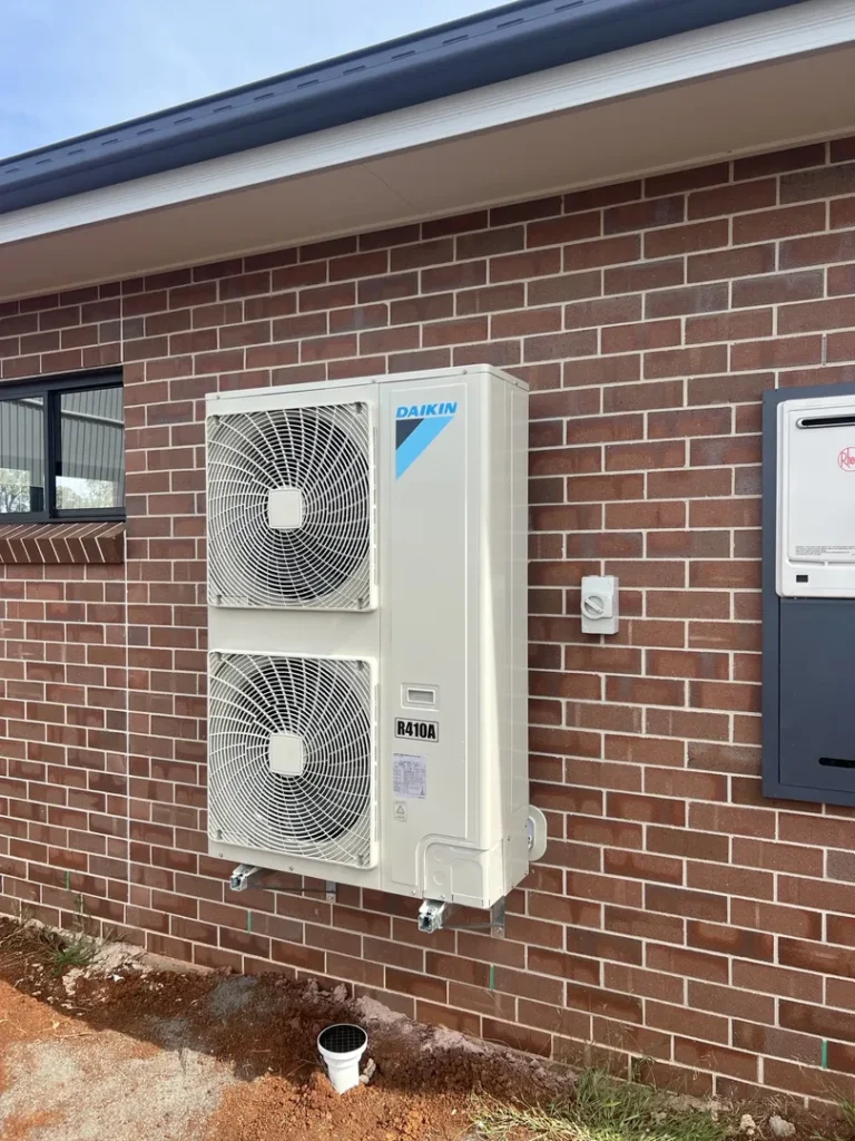 Daikin outdoor air conditioning unit on brick wall