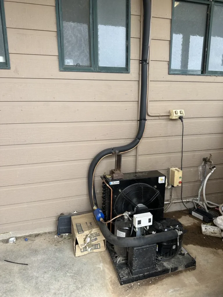 Air conditioning unit installed outside house.