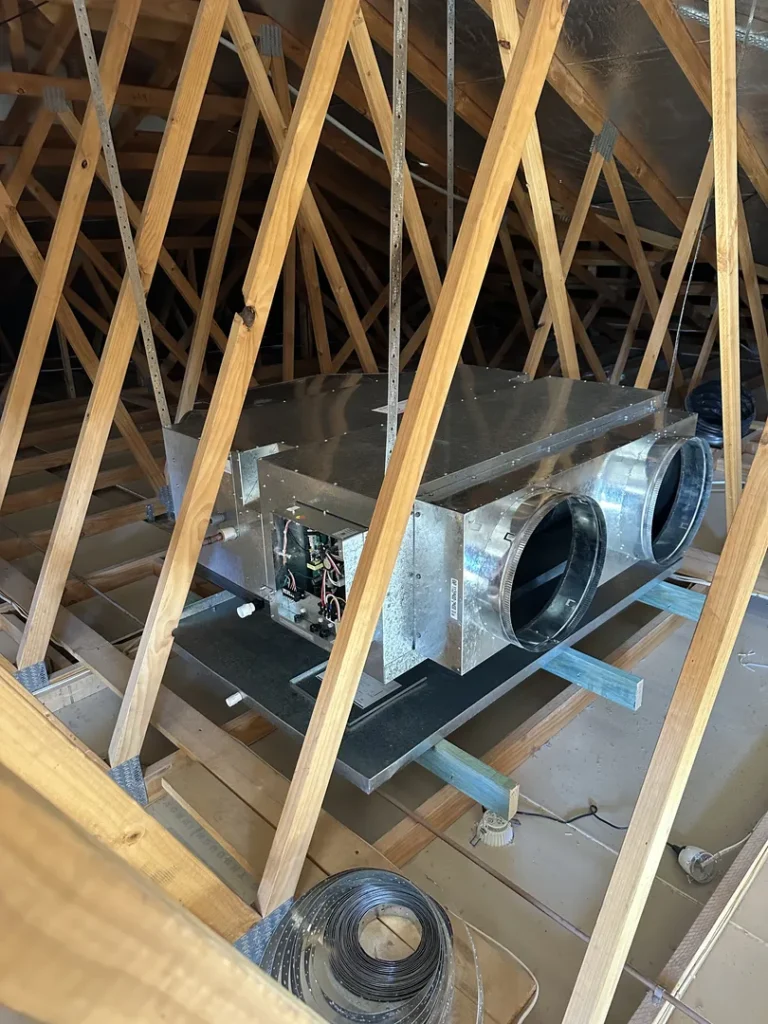 HVAC unit installed in attic with wooden supports.