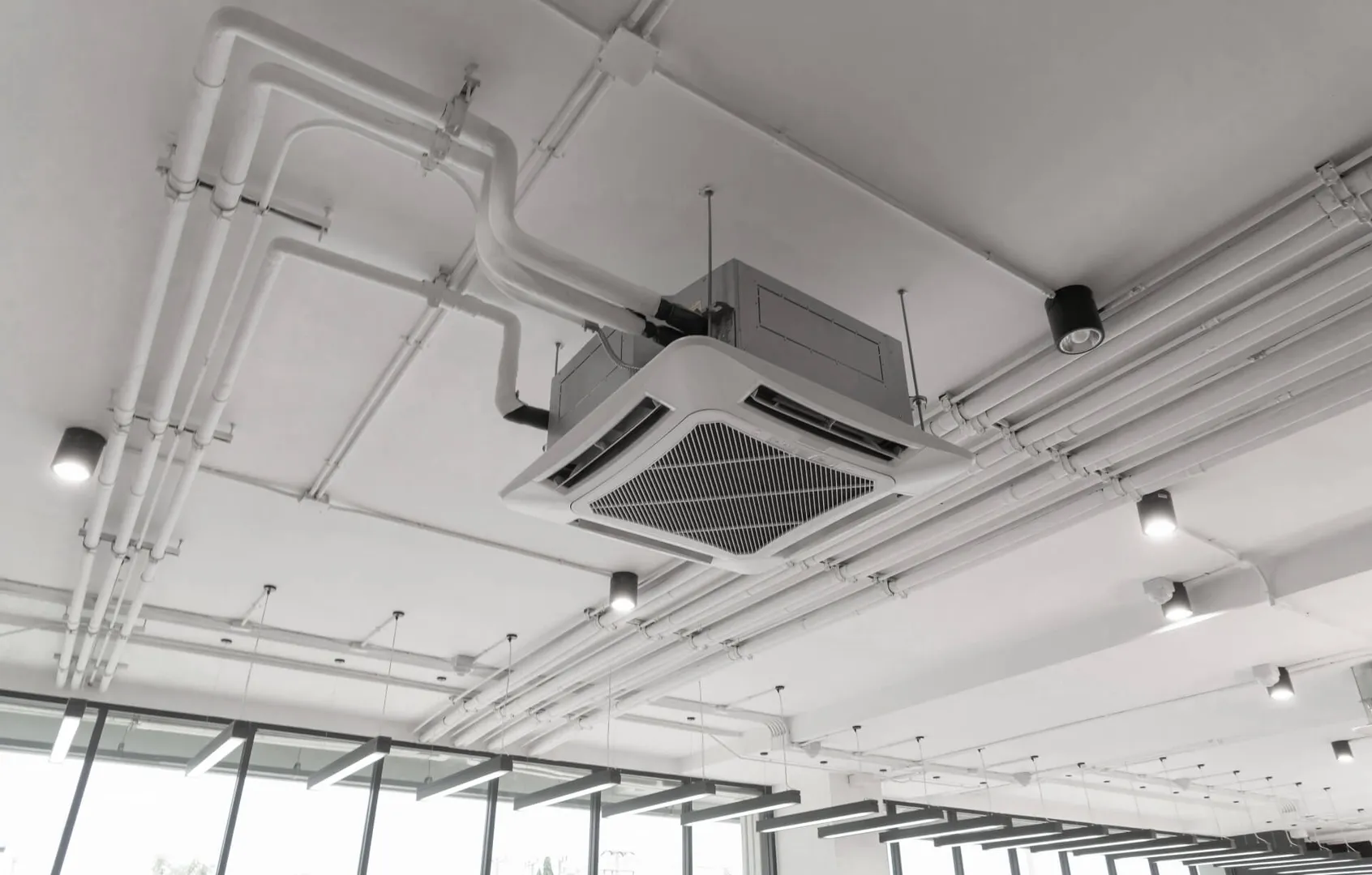 Air conditioning unit on office ceiling.